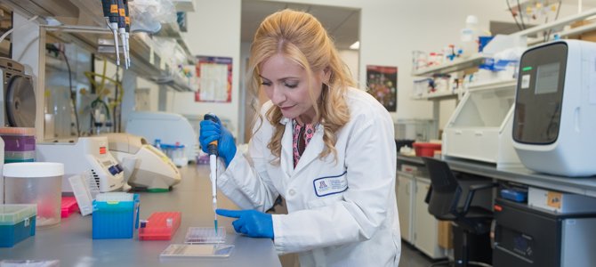 Melissa Herbst-Kralovetz Doing Work in Her Lab