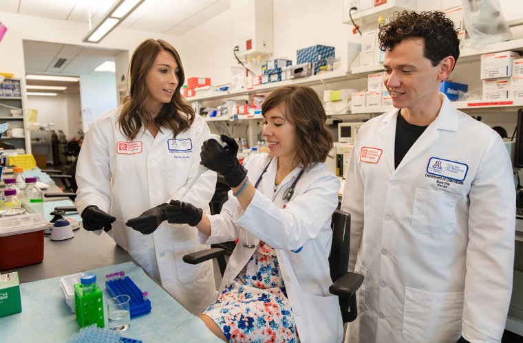 Rachel Rowe, PhD, Alona Sukhina, MD, and  J. Bryce Ortiz, PhD, Working in the Lab