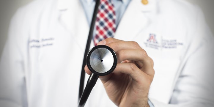 Up Close Picture of a Stethoscope Being Held by a Physician