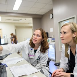 Dr. Christina Bergin Works with a Resident at Banner